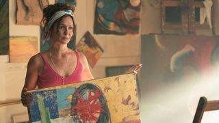 Lucia (Florencia Lozano) holds a painting in Keep Breathing.