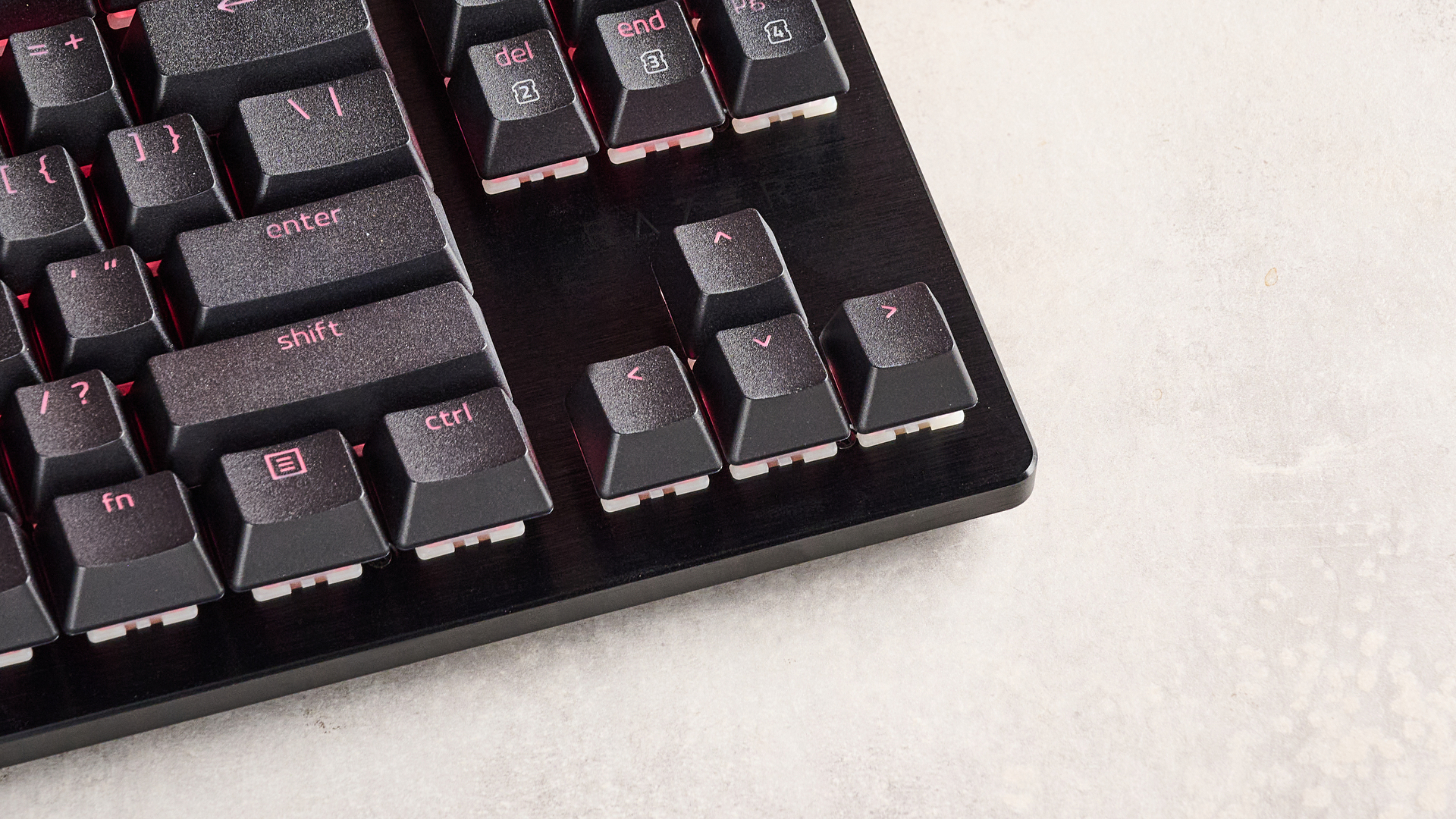 Close-up of arrow keys on Razer Huntsman V3 HE Magnetic Tenkeyless 8KHz on desk