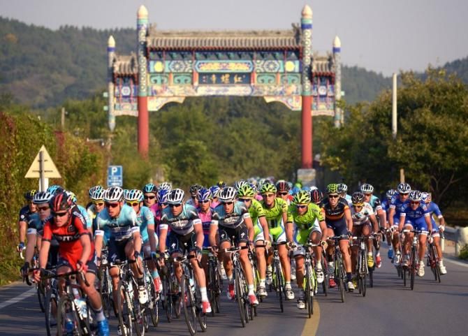 Cyclists ride through a country road during the first stage of the 2013 Tour of Beijing