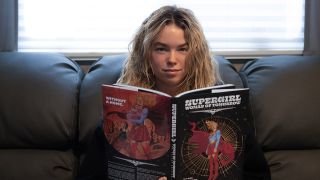 Milly Alcock reading the Supergirl: Woman of Tomorrow comic book