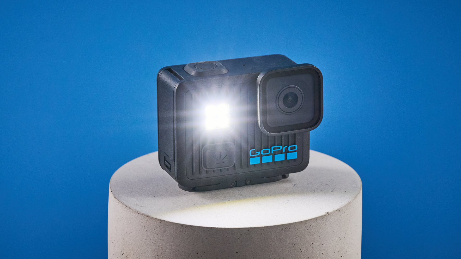 The GoPro LIT Hero against a blue background