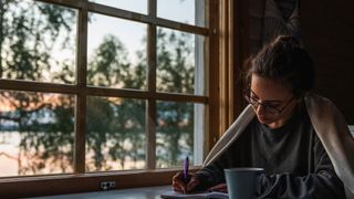 How to relax: A woman writing in a journal