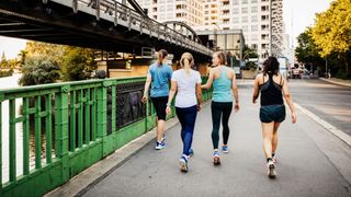 Group of women in running clothes doing walking as a workout in the city