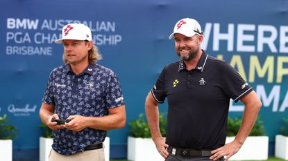 Cameron Smith uses a remote-controlled BMW toy car while Marc Leishman watches on ahead of the Australian PGA Championship