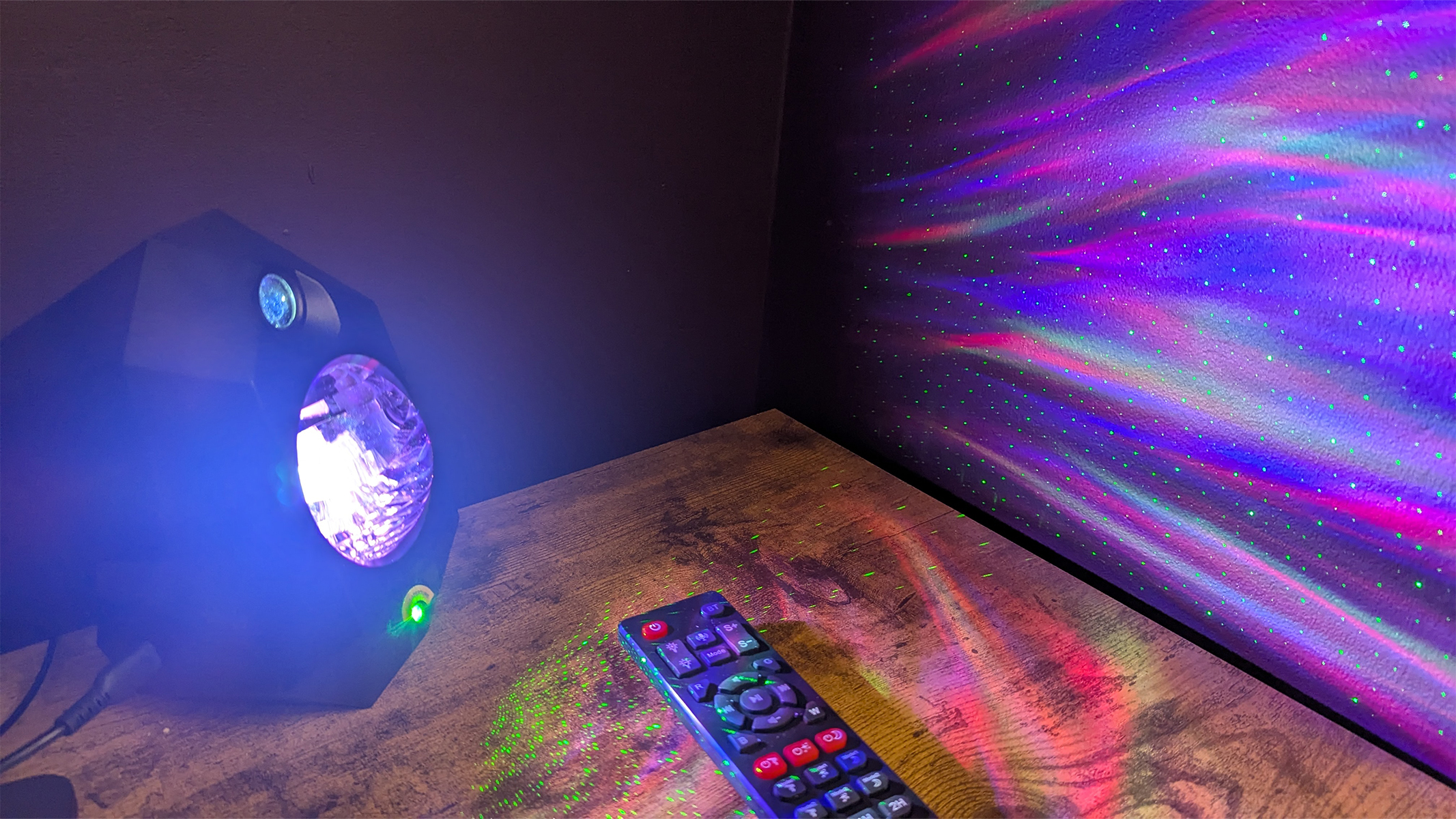 Cadrim Star Projector on a table next to a remote control