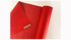 Image shows a partly unrolled JadeYoga Travel Mat.