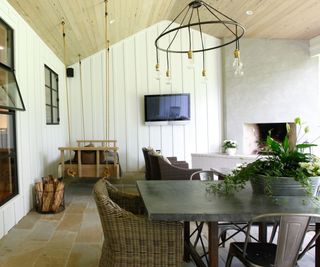 Outdoor tv on wall of outdoor dining space