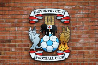 The Coventry City badge on a brick wall at the club's training ground