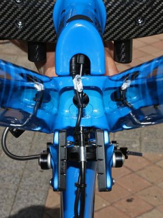 The internally routed cables come down through the lower stem and then jump over into the bottom of the down tube.