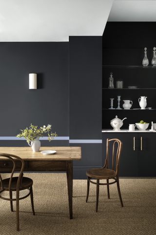 dark blue dining room with coir carpet, white ceiling, glass shelving, white and glass display