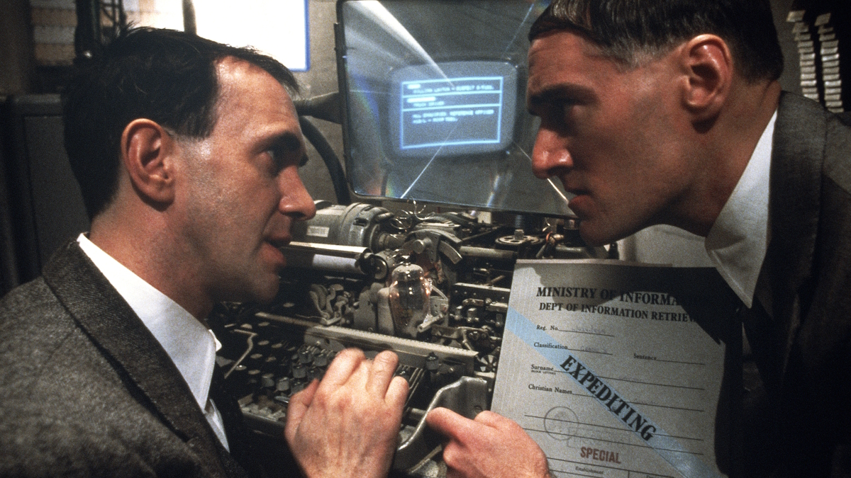 Two men sit in front of a computer in Brazil