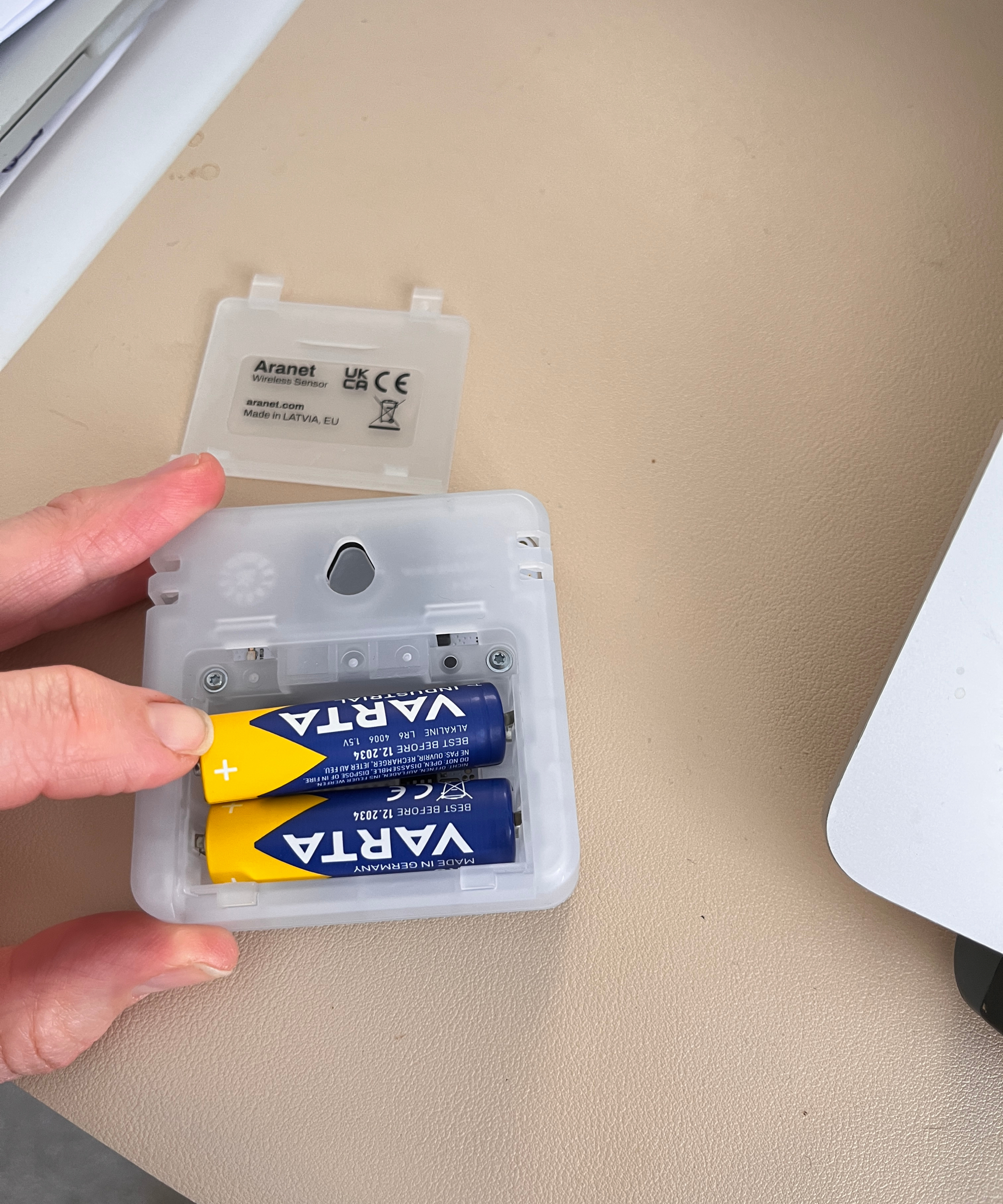 batteries being inserted into the back of the  Aranet4 Home monitor