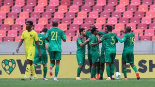 Percy Tau celebrates his goal with teammates