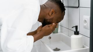 Man washing his face