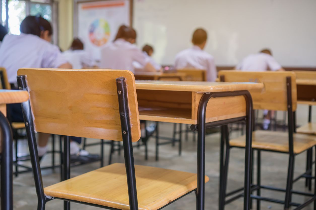 An empty desk in a classroom