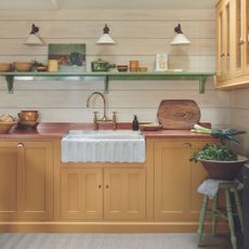 coastal kitchen with yellow cabinetry and butler sink