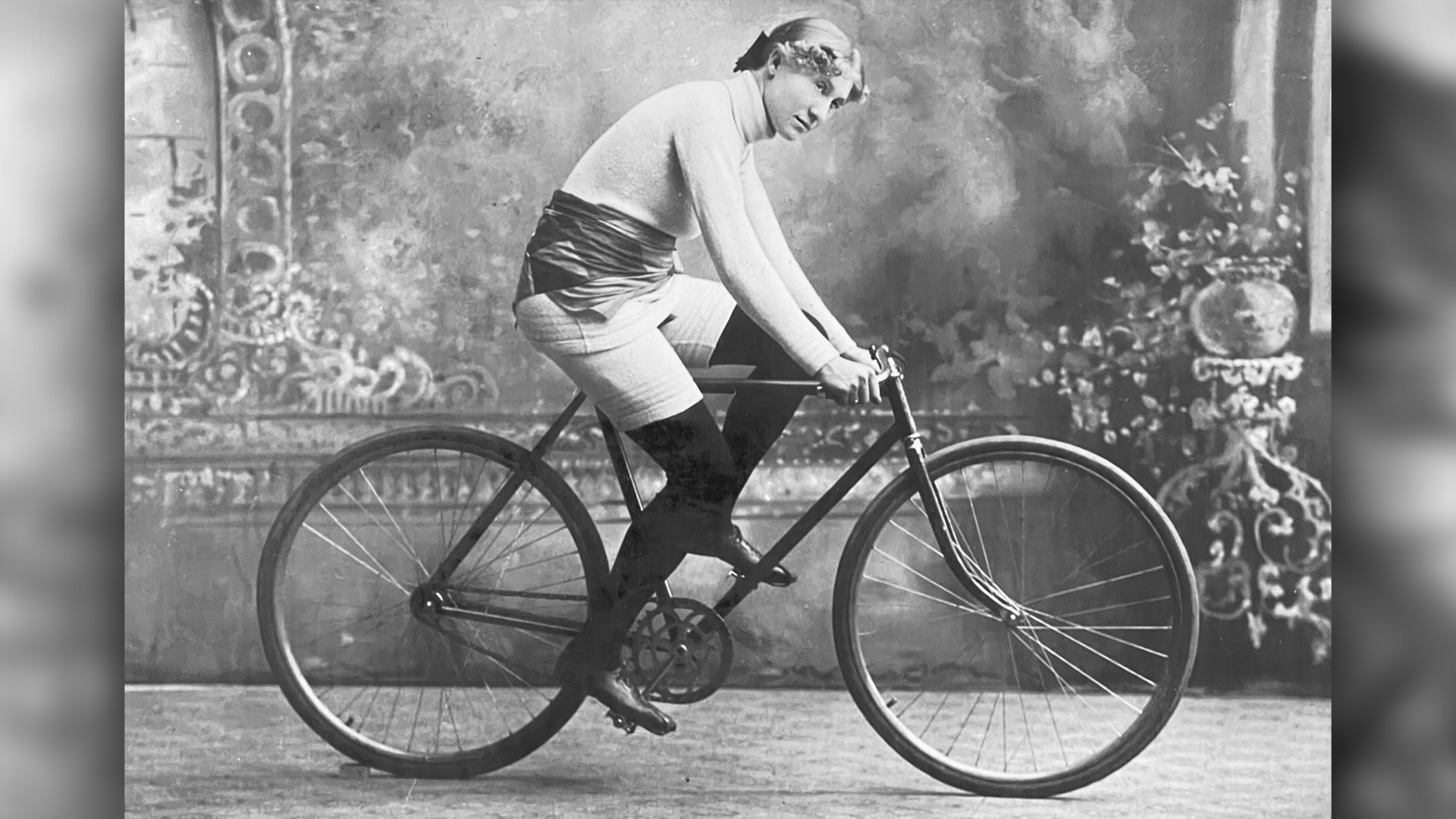 Racing cyclist Tillie Anderson sitting on her bike. in 1896, the League of American Wheelmen recognized her as the best woman cyclist in the world.