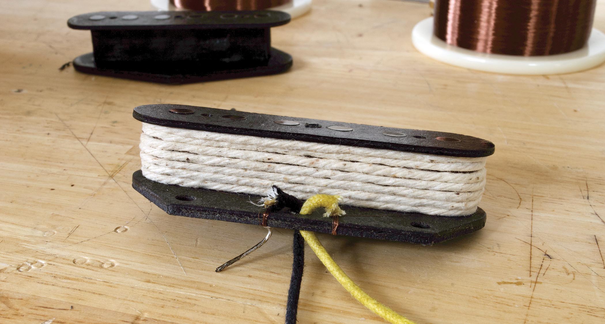 Wrapping the string around the coil provides the protection needed before soldering the leadout wires and fixing the baseplate