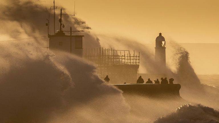 Storm Eunice arrives, sending Waves crash against the harbour wall in Wales