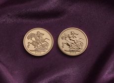 Two gold 2025 sovereign coins on a purple velvet backdrop