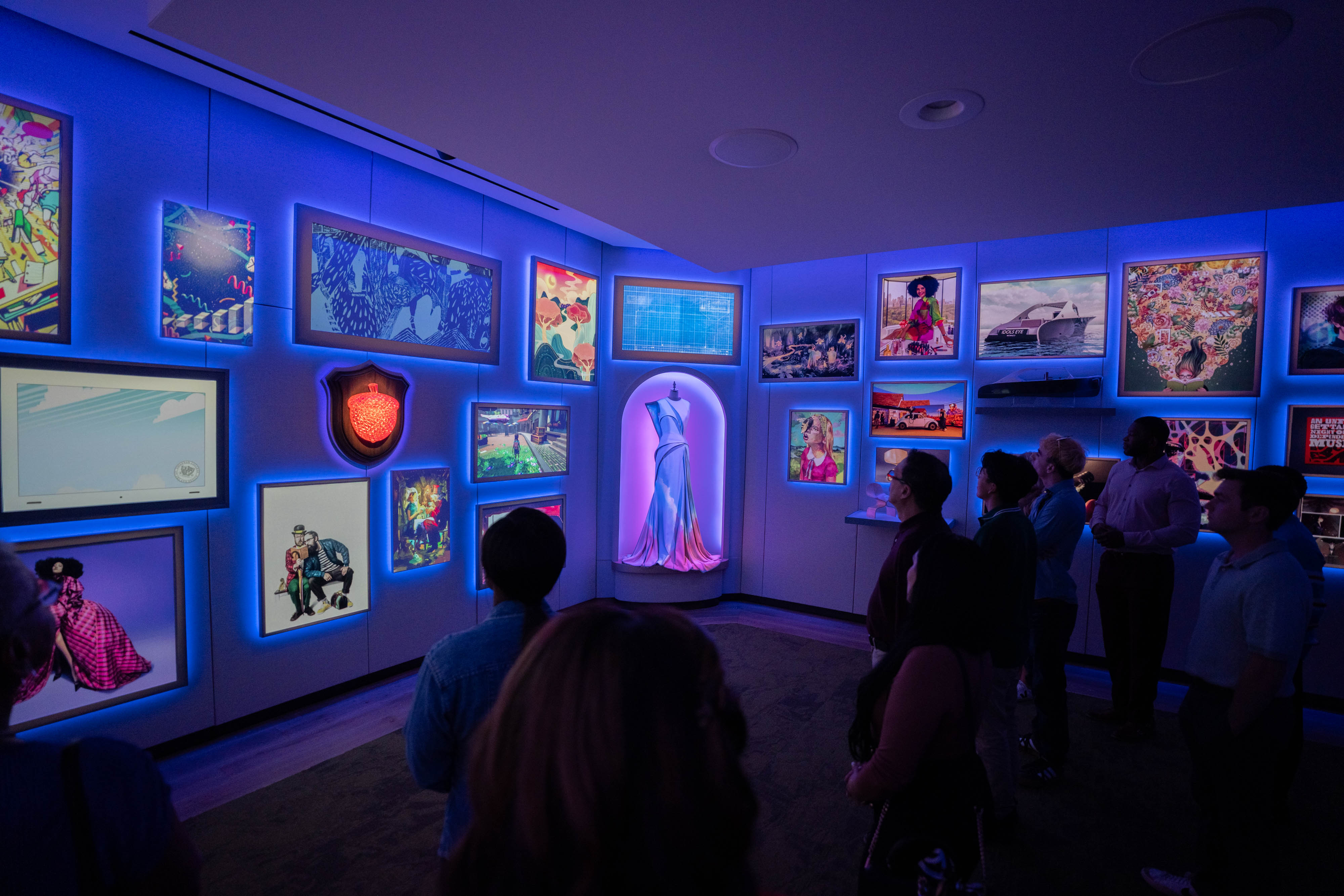 blue room with lots of things to look at in it in display cases/on the walls