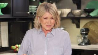 Martha Stewart in button-up shirt baking a cake