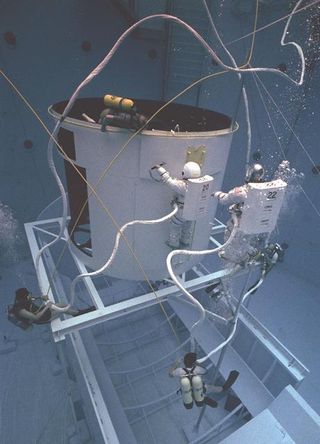 Astronauts practicing Hubble repair work in the Neutral Buoyancy Simulator at NASA's Marshall Space Flight Center in Alabama.