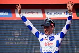 The best climber, Team Lotto's Sylvain Moniquet celebrates on the podium wearing the dot jersey after the stage 6 of La Vuelta a Espana cycling tour, a 185.5 km race between Jerez de la Frontera and Yunquera, on August 22, 2024. (Photo by CRISTINA QUICLER / AFP)