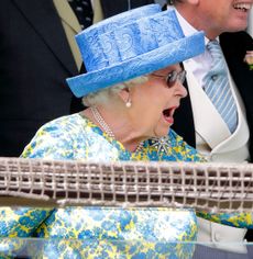 Queen Elizabeth reacting a blue hat and floral dress shouting