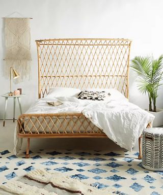 A rattan bed frame in a light and right bedroom