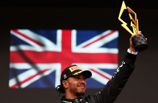 Lewis Hamilton lifting a trophy
