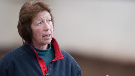 Pammy Hutton wearing a navy jumper with a red collar