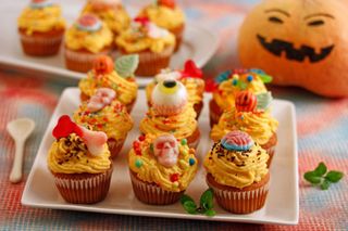 Halloween party ideas illustrated by pumpkin spooky orange cupcakes