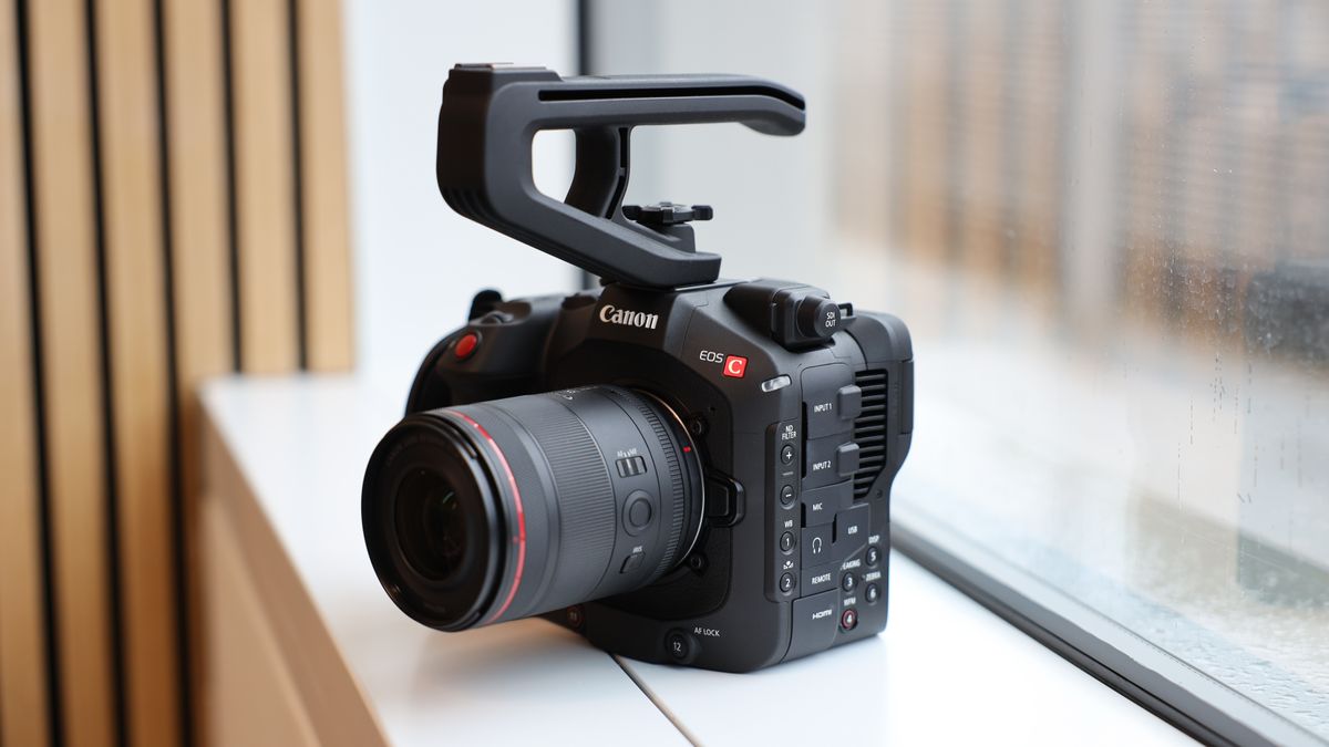 Canon EOS C80 cinema camera on a white windowsill in front of a large window