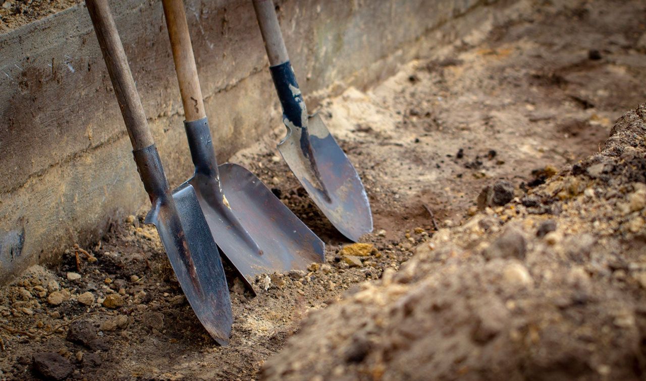 Three Shovels In A Drainage Ditch