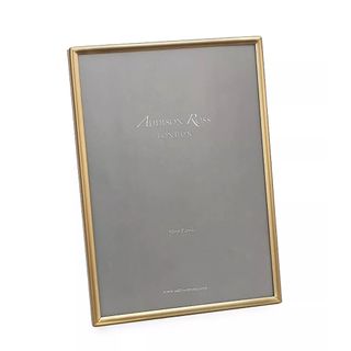 gold frame from addison ross with a gray background
