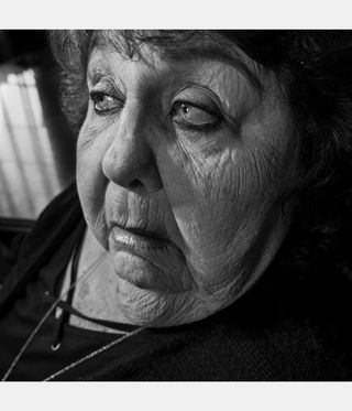 black and white image from Larry Fink photography book showing close-up of woman's face