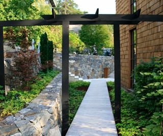 a side yard designed by Annika Zetterman, with archway and path