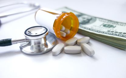 medicine pills on dollars