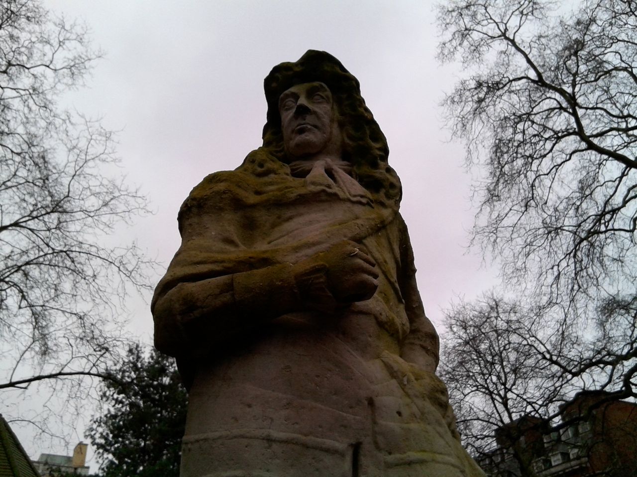 Photo of a statue in front of some trees