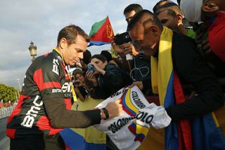Cadel Evans of Australia signs autographs for fans following stage 21 of the 2015 Tour de France