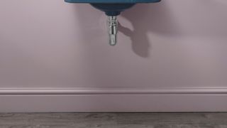 pale pink wall in bathroom with matching skirting and wall hung basin