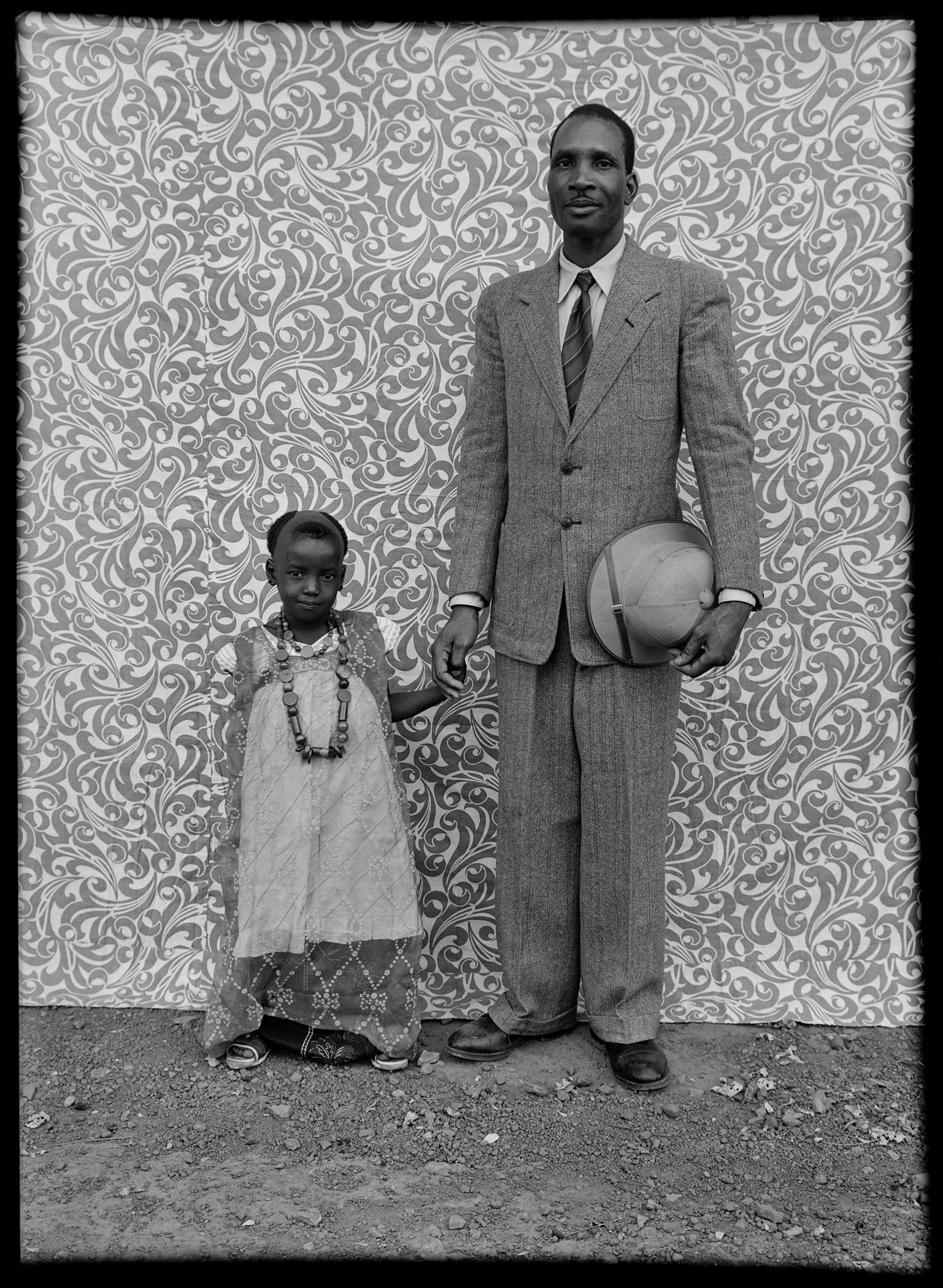 black and white portrait by Seydou Keïta of a man and child