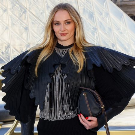 Sophie Turner arrived at the Louis Vuitton Spring 2026 fashion show in fall's slouchy boot trend 