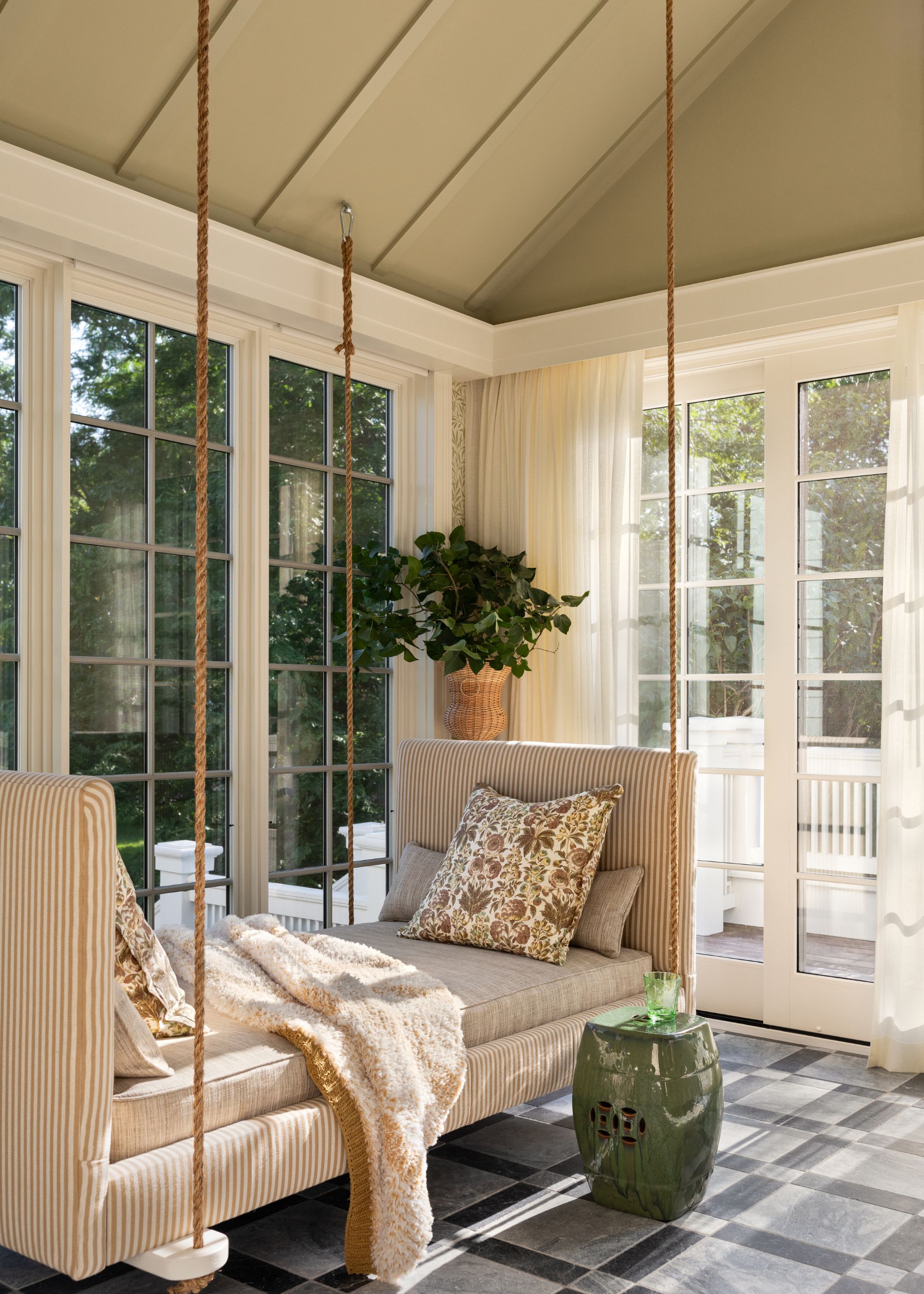 sunroom with French doors and a hanging daybed seat