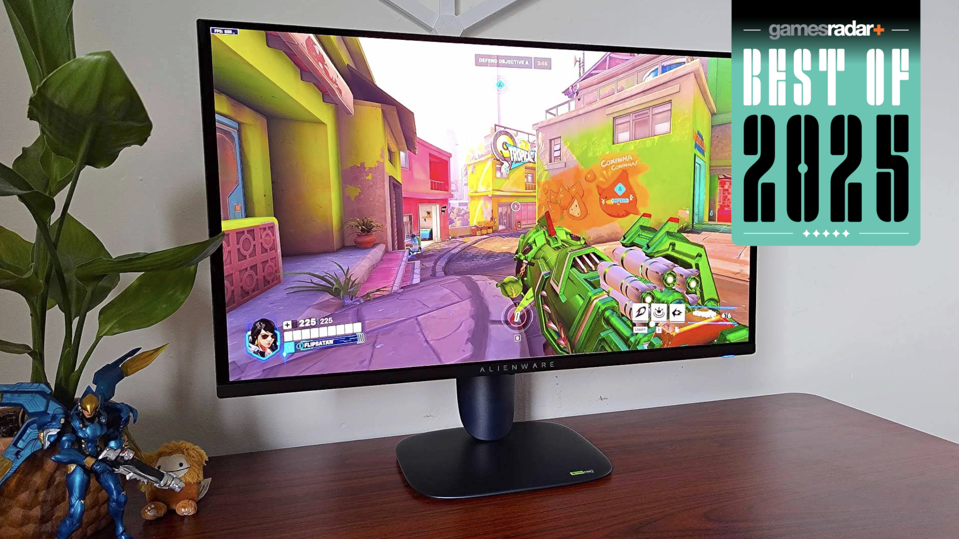 Alienware AW2725Q on a wooden desk with 'best of 2025' badge