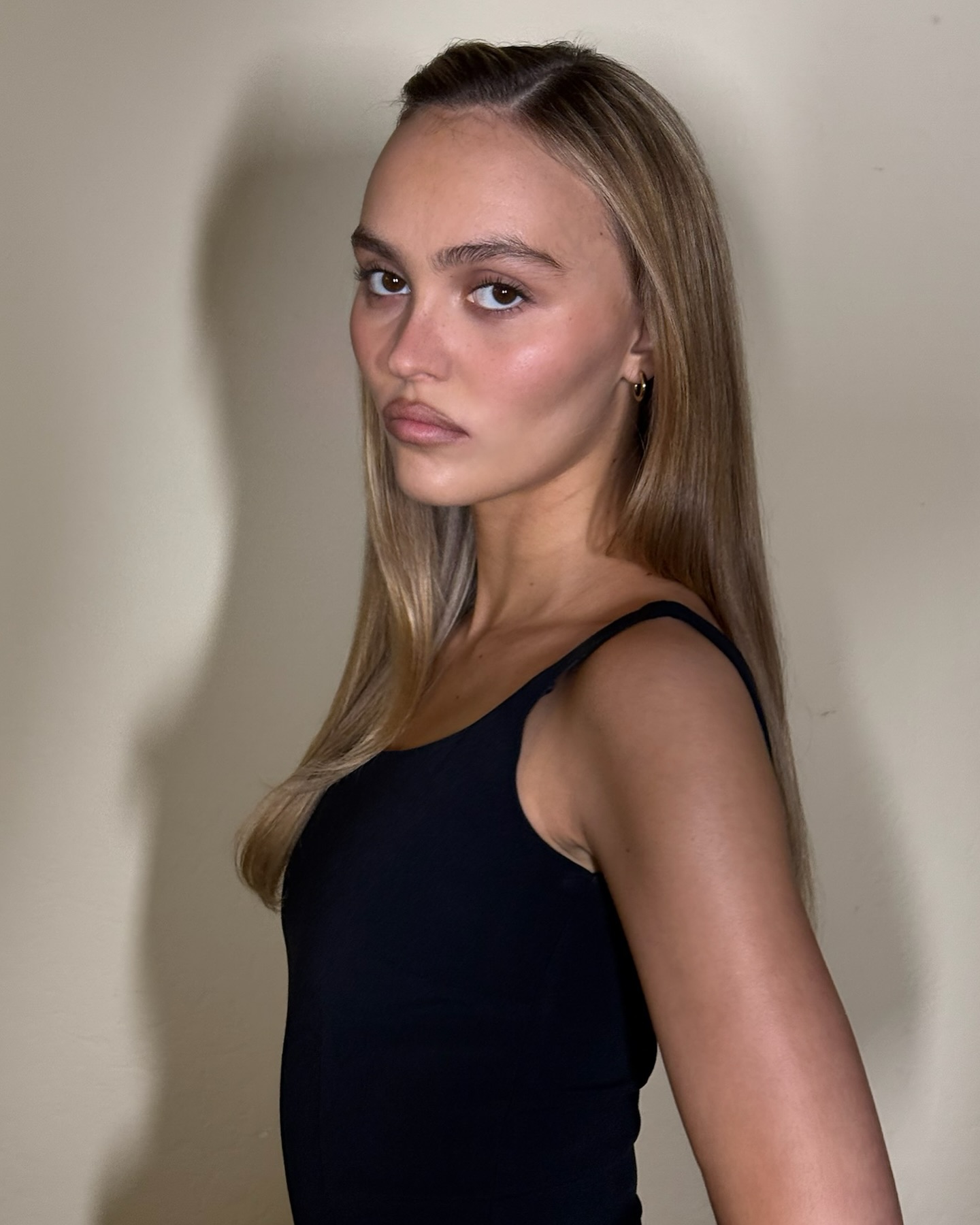 Lily-Rose Depp with long dark blonde hair