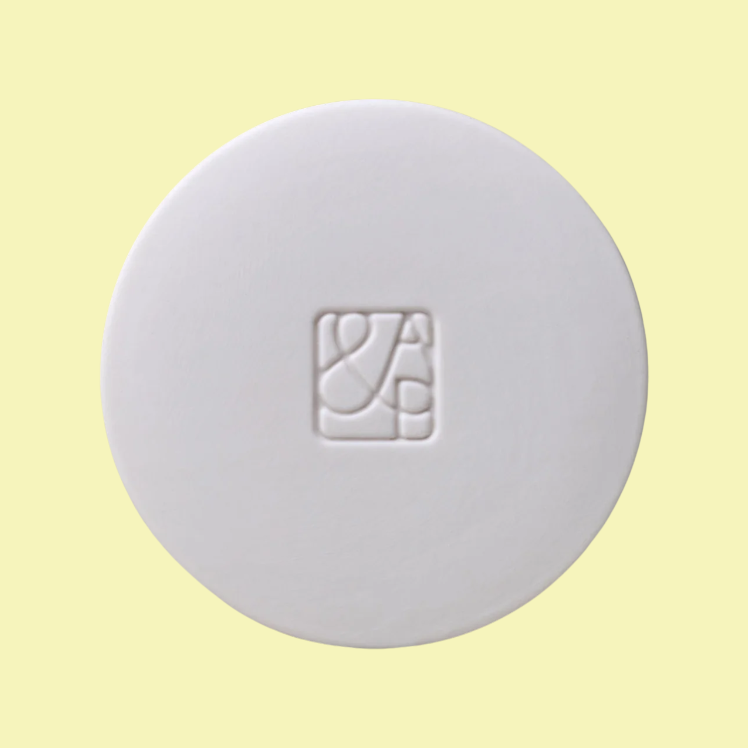 A white ceramic candle lid