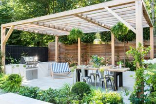 large pergola over modern outdoor kitchen and seating area