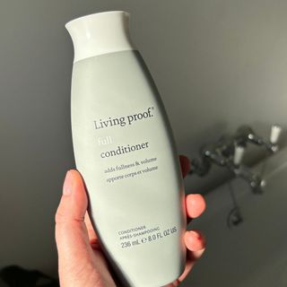 Laura holding Living Proof Full Conditioner - best hair conditioner